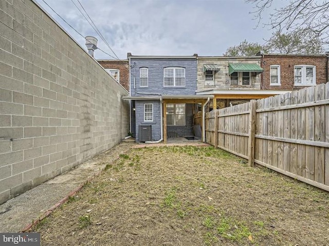 905 E Patapsco Ave, Baltimore, MD 21225 - rear view of house with a fenced backyard and central air condition unit