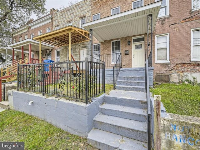 905 E Patapsco Ave, Baltimore, MD 21225 - view of front of property with brick siding and a porch