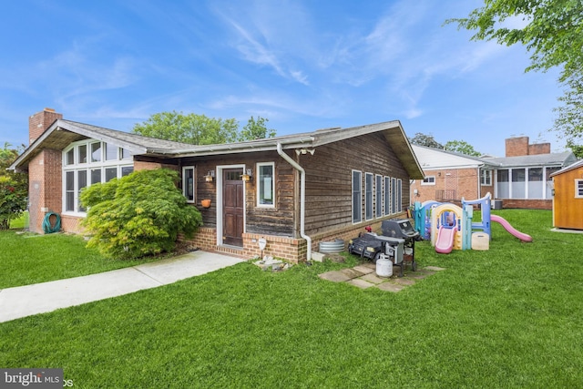 2400 Willow Glen Dr, Baltimore, MD 21209 - view of front of home with a front lawn, a chimney, and brick siding