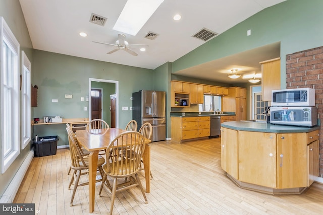 2400 Willow Glen Dr, Baltimore, MD 21209 - dining space featuring light wood-type flooring, a skylight, vaulted ceiling, and ceiling fan