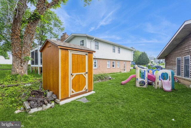 2400 Willow Glen Dr, Baltimore, MD 21209 - rear view of house with a storage unit, a yard, a chimney, an outdoor structure, and a playground