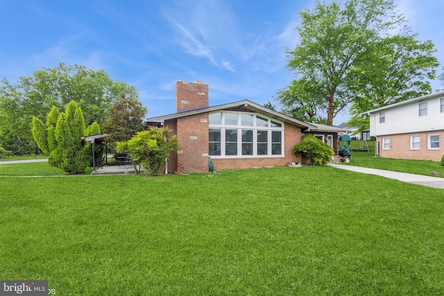 2400 Willow Glen Dr, Baltimore, MD 21209 - rear view of house featuring a chimney, a yard, and brick siding