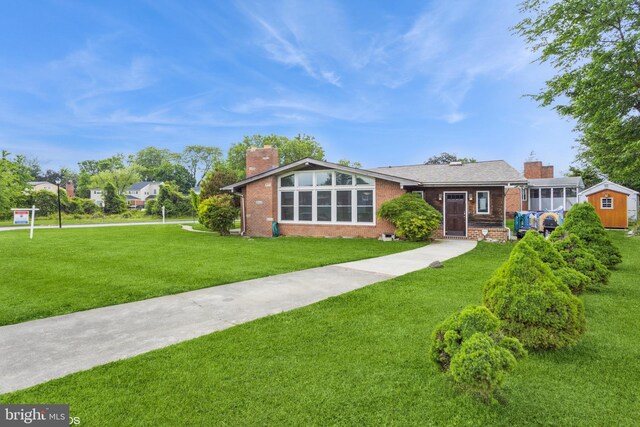 2400 Willow Glen Dr, Baltimore, MD 21209 - mid-century modern home featuring a chimney, brick siding, a front yard, and driveway
