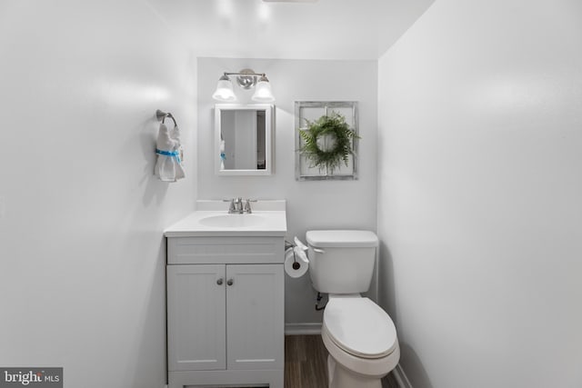 9761 Turnbuckle Dr, Burke, VA 22015 - half bath with vanity, toilet, baseboards, and wood finished floors