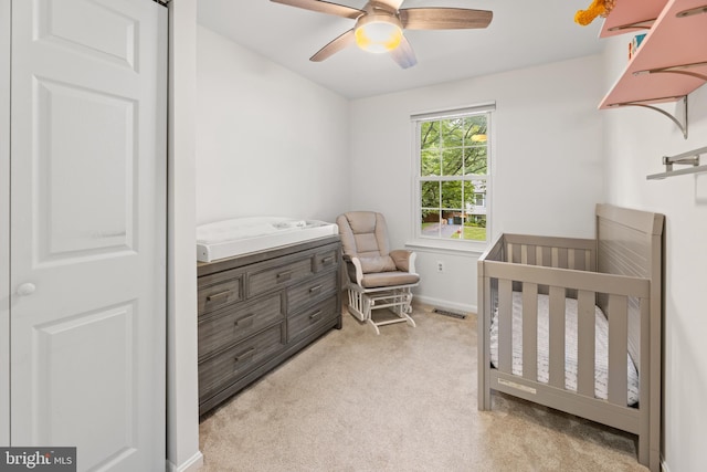 9761 Turnbuckle Dr, Burke, VA 22015 - bedroom featuring light carpet, a nursery area, ceiling fan, and baseboards