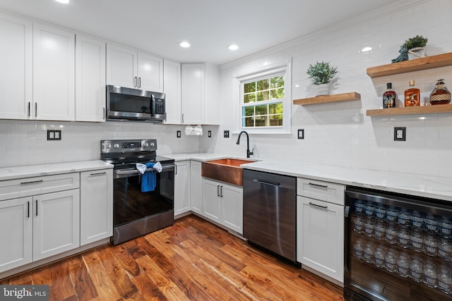 9761 Turnbuckle Dr, Burke, VA 22015 - kitchen with appliances with stainless steel finishes, beverage cooler, a sink, open shelves, and decorative backsplash