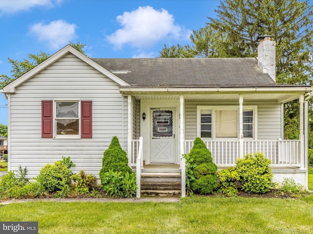 510 E Main St, Emmitsburg, MD 21727 - bungalow-style house featuring a chimney, roof with shingles, a front lawn, and a porch