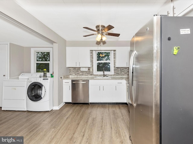 510 E Main St, Emmitsburg, MD 21727 - kitchen featuring stainless steel appliances, a sink, light wood-type flooring, and washer and clothes dryer