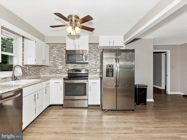 510 E Main St, Emmitsburg, MD 21727 - kitchen featuring stainless steel appliances, a sink, light wood finished floors, and decorative backsplash