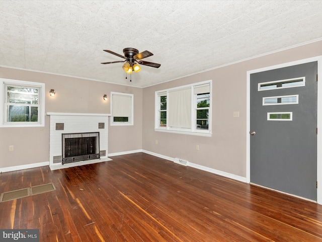 510 E Main St, Emmitsburg, MD 21727 - unfurnished living room featuring plenty of natural light, ceiling fan, hardwood / wood-style floors, crown molding, and a brick fireplace