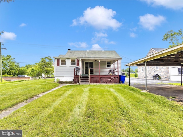 510 E Main St, Emmitsburg, MD 21727 - view of front of house with a front yard, asphalt driveway, a carport, and a wooden deck