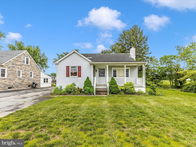 510 E Main St, Emmitsburg, MD 21727 - view of front of home featuring a porch, a chimney, asphalt driveway, and a front lawn