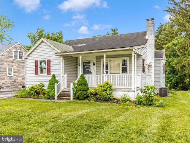 510 E Main St, Emmitsburg, MD 21727 - view of front of house with covered porch, central AC, a front yard, a chimney, and a shingled roof
