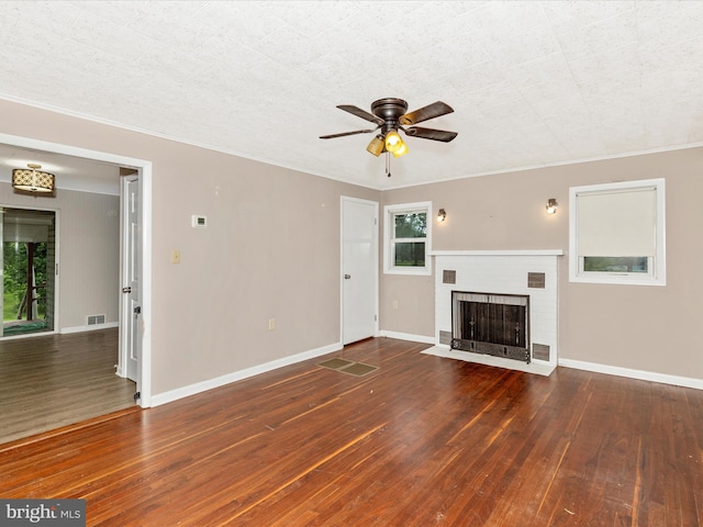 510 E Main St, Emmitsburg, MD 21727 - unfurnished living room with wood-type flooring, ceiling fan, a brick fireplace, baseboards, and ornamental molding
