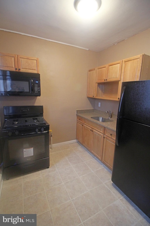 1826 N 52nd St, Philadelphia, PA 19131 - kitchen with black appliances, a sink, baseboards, and light brown cabinetry