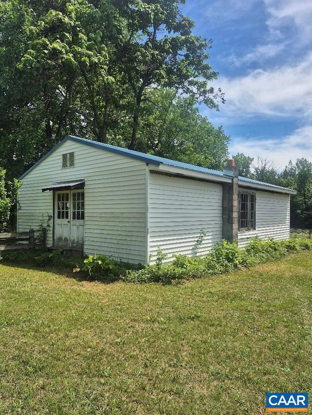 566 Holman Mill Rd, Farmville, VA 23901 - view of property exterior featuring a lawn, metal roof, and a chimney