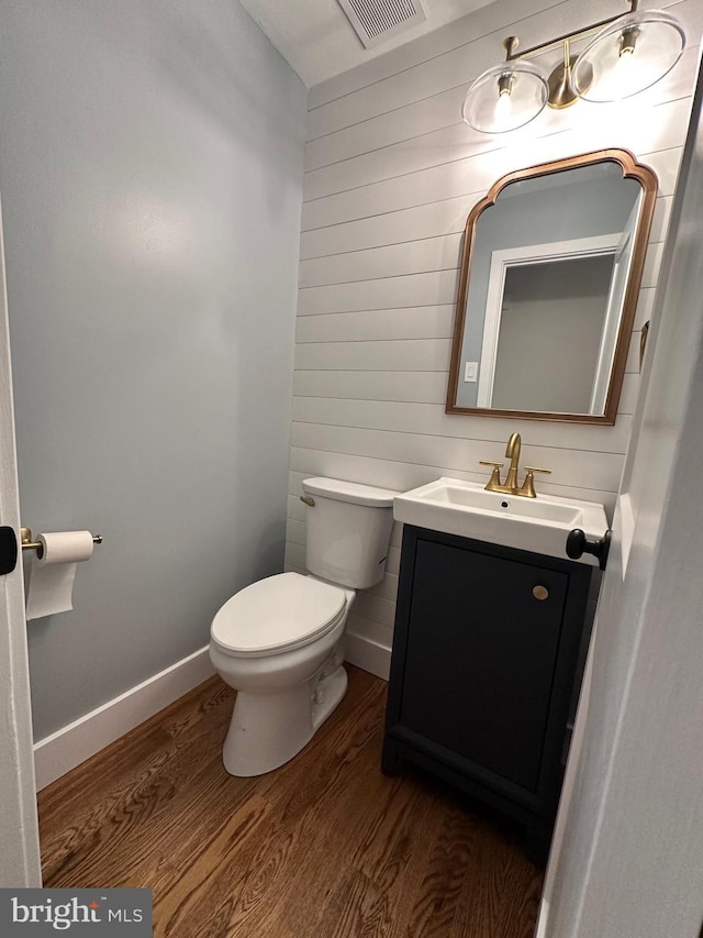 215 Bridge Rd, Upper Chichester, PA 19061 - bathroom featuring wood finished floors, toilet, vanity, and baseboards