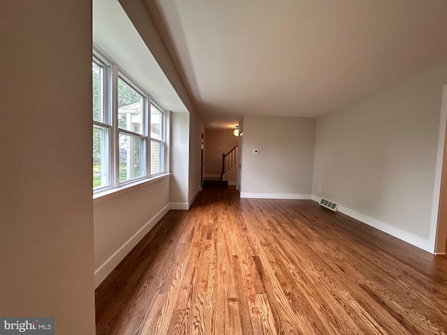 215 Bridge Rd, Upper Chichester, PA 19061 - empty room with wood finished floors, baseboards, and stairway