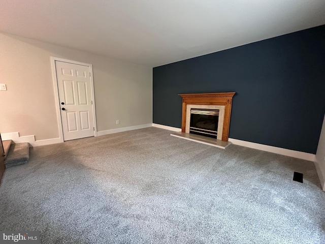 215 Bridge Rd, Upper Chichester, PA 19061 - unfurnished living room with carpet floors, a glass covered fireplace, and baseboards