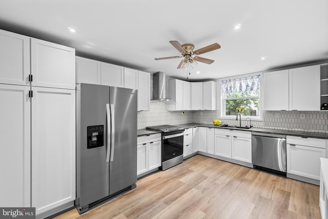 3342 Belgrade St, Philadelphia, PA 19134 - kitchen featuring appliances with stainless steel finishes, wall chimney exhaust hood, a sink, dark countertops, and recessed lighting
