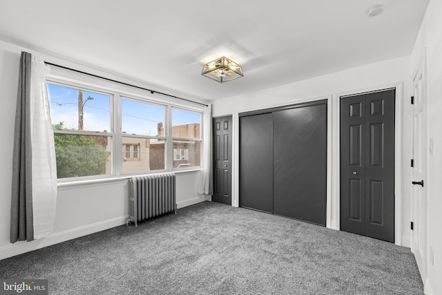 3342 Belgrade St, Philadelphia, PA 19134 - unfurnished bedroom with radiator heating unit, carpet flooring, multiple closets, and baseboards