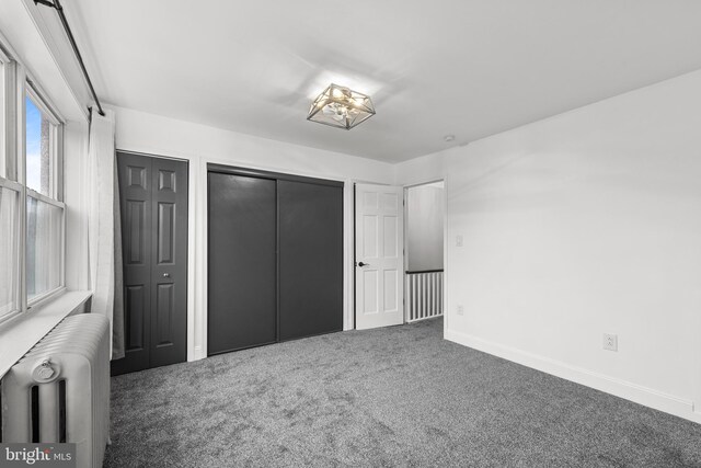 3342 Belgrade St, Philadelphia, PA 19134 - unfurnished bedroom featuring radiator heating unit, carpet, baseboards, and multiple closets
