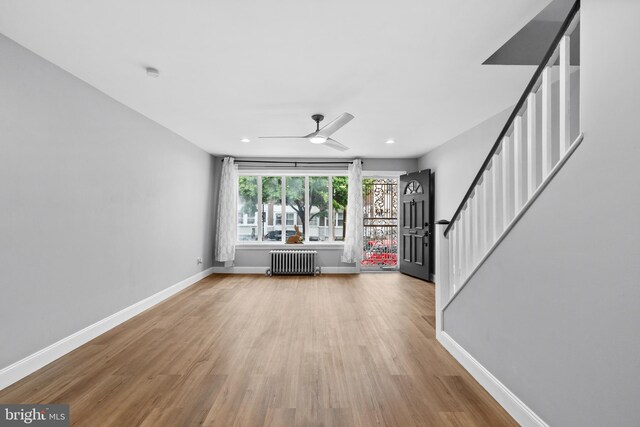 3342 Belgrade St, Philadelphia, PA 19134 - unfurnished living room featuring radiator, baseboards, a ceiling fan, wood finished floors, and recessed lighting