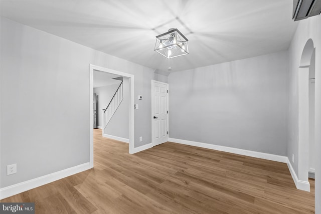 3342 Belgrade St, Philadelphia, PA 19134 - unfurnished dining area with baseboards, wood finished floors, stairway, and a wall mounted air conditioner