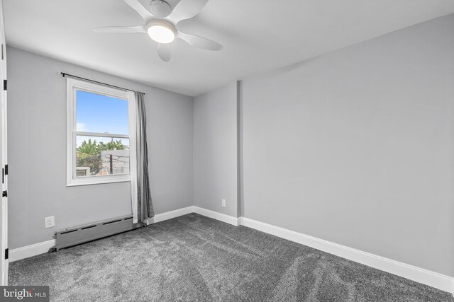 3342 Belgrade St, Philadelphia, PA 19134 - unfurnished room with a baseboard heating unit, dark carpet, baseboards, and ceiling fan