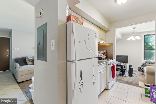 kitchen featuring white appliances, light tile patterned flooring, electric panel, under cabinet range hood, and a chandelier