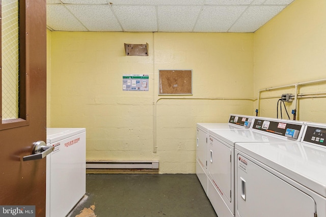 community laundry room with washing machine and dryer and a baseboard radiator