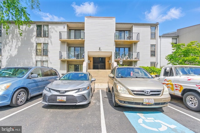 view of building exterior featuring uncovered parking