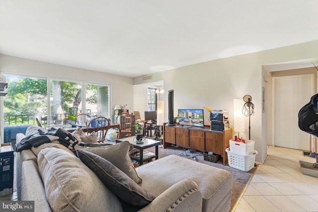 living area with plenty of natural light and light tile patterned floors