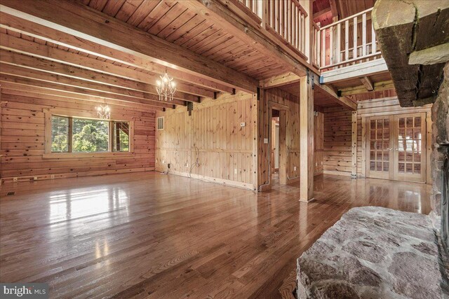 21142 Westerly Rd, Poolesville, MD 20837 - unfurnished bedroom featuring a chandelier, wooden walls, wood finished floors, and beamed ceiling