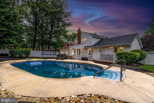 520 Perry Dr, Mount Laurel, NJ 08054 - pool at dusk featuring a trampoline and a patio