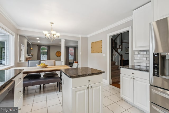 520 Perry Dr, Mount Laurel, NJ 08054 - kitchen with appliances with stainless steel finishes, a chandelier, light tile patterned floors, dark stone counters, and crown molding