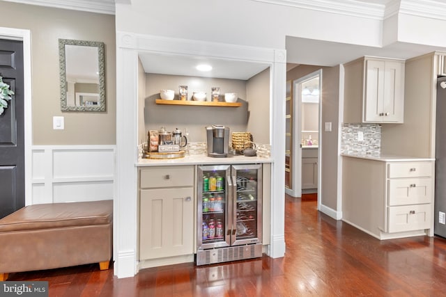 602 Tallowood Ln, Mount Laurel, NJ 08054 - indoor dry bar featuring wine cooler, dark wood finished floors, crown molding, backsplash, and a wainscoted wall