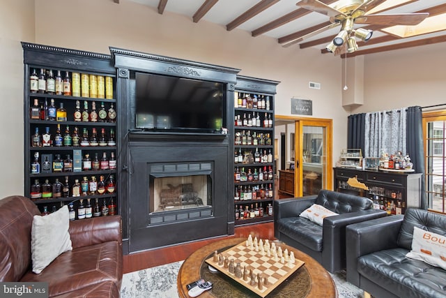 602 Tallowood Ln, Mount Laurel, NJ 08054 - living area with wood finished floors, ceiling fan, beam ceiling, and a fireplace