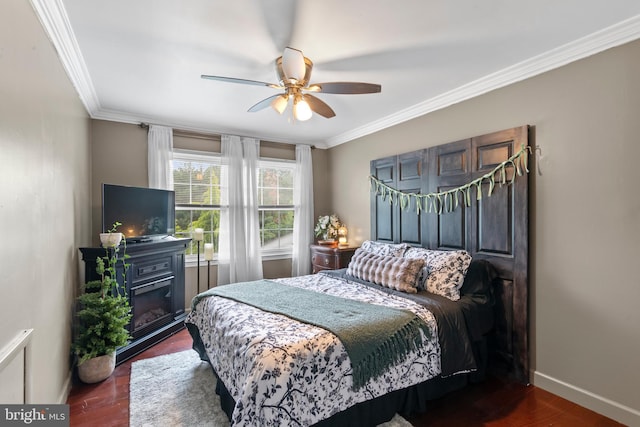 602 Tallowood Ln, Mount Laurel, NJ 08054 - bedroom with crown molding, baseboards, dark wood finished floors, a ceiling fan, and a glass covered fireplace