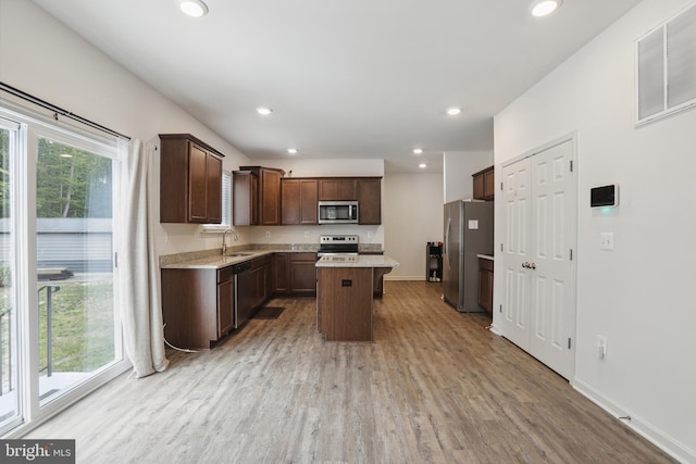 11041 Lee St, King George, VA 22485 - kitchen featuring stainless steel appliances, light wood-style flooring, recessed lighting, a center island, and dark brown cabinetry