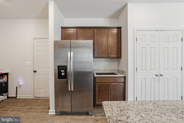 11041 Lee St, King George, VA 22485 - kitchen with stainless steel refrigerator with ice dispenser, light wood finished floors, light stone countertops, and baseboards