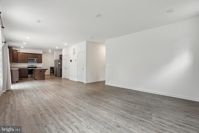 11041 Lee St, King George, VA 22485 - unfurnished living room with light wood finished floors, baseboards, and recessed lighting