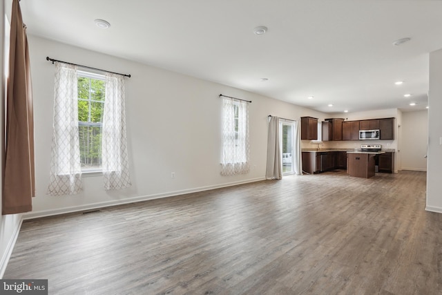11041 Lee St, King George, VA 22485 - unfurnished living room featuring recessed lighting, wood finished floors, baseboards, and a sink