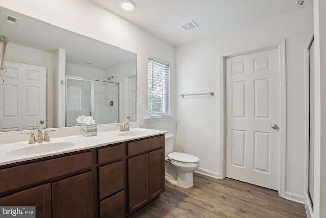11041 Lee St, King George, VA 22485 - full bath featuring a shower stall, wood finished floors, toilet, and double vanity