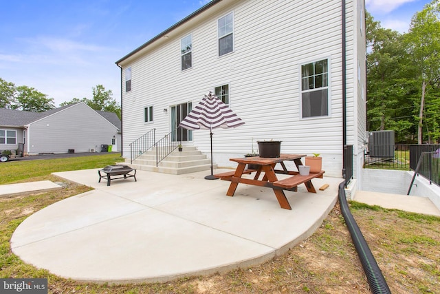 11041 Lee St, King George, VA 22485 - rear view of property with cooling unit, a patio, and a fire pit