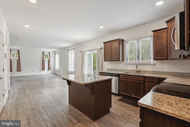 11041 Lee St, King George, VA 22485 - kitchen with a sink, stainless steel appliances, a center island, open floor plan, and light stone counters