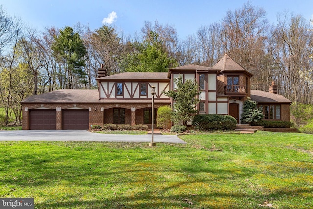 79 Country Club Rd, Ashland, PA 17921 - tudor-style house with a chimney, an attached garage, a front lawn, a balcony, and asphalt driveway