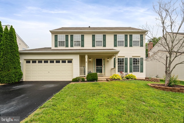 9235 Stephanie St, Manassas Park, VA 20111 - colonial home with asphalt driveway, a porch, and a front yard