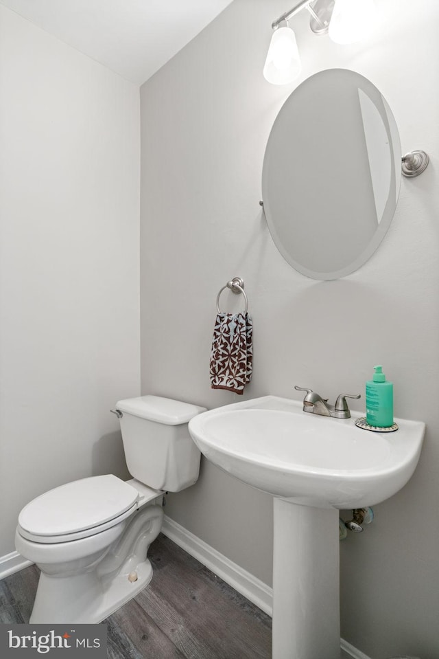 9235 Stephanie St, Manassas Park, VA 20111 - bathroom with wood finished floors, toilet, baseboards, and a sink
