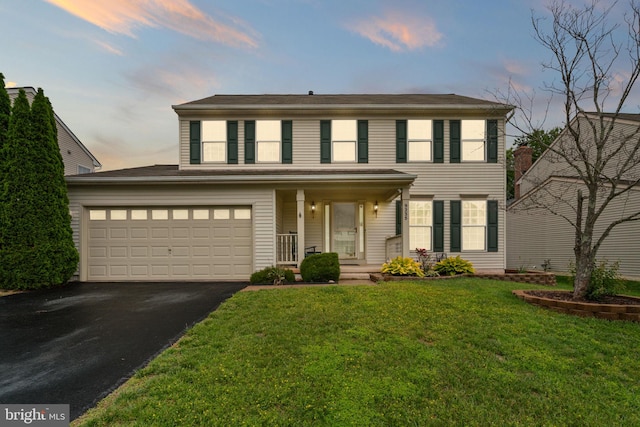 9235 Stephanie St, Manassas Park, VA 20111 - view of front facade featuring driveway, covered porch, and a front yard